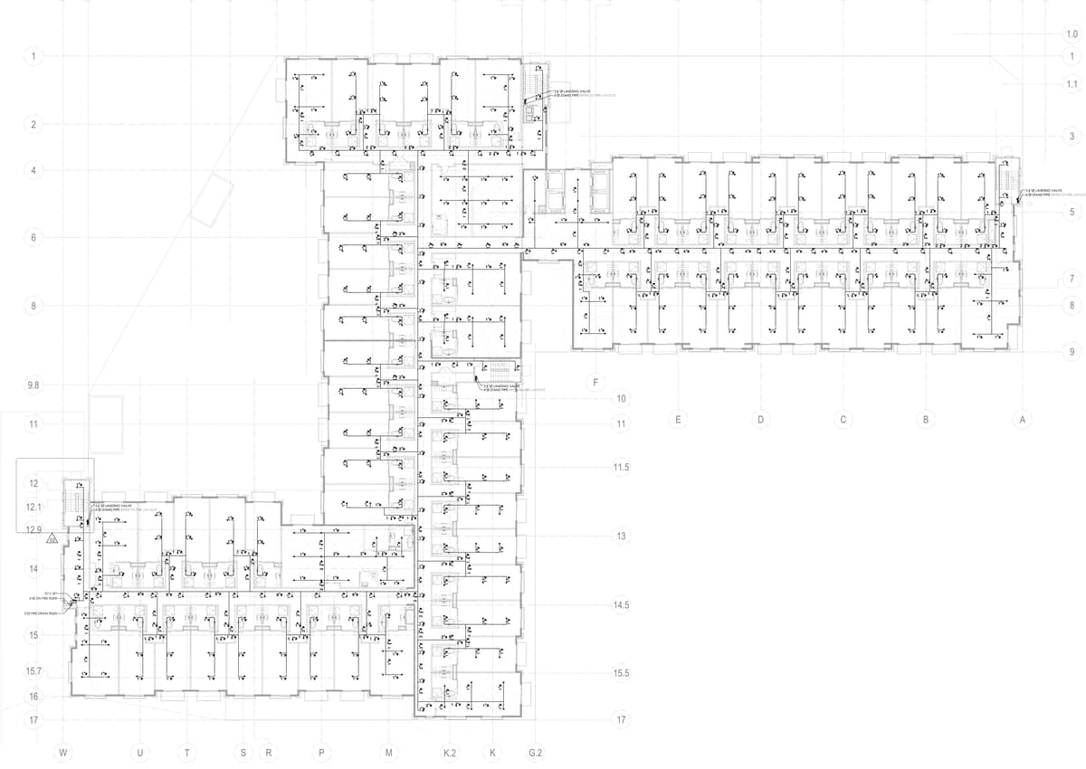 Fire sprinkler layout of a typical hotel floor with branch lines to every guest room, pipe sizes and standpipe landing valves in the stairs. Seven-storey hotel and resort, California, MEP design by Ahmad Akra